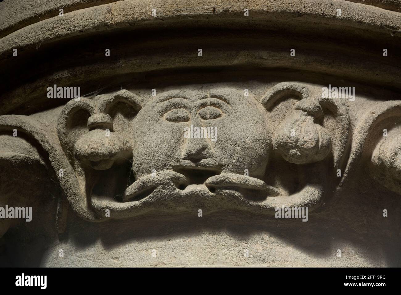 Carved green man capital inside St. Mary`s Church, Woodford, Northamptonshire, England, UK Stock Photo